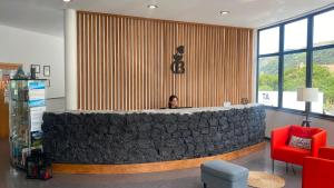 a man sitting at a bar in a lobby at Cantinho das Buganvilias AT**** in Queimada +77 photos