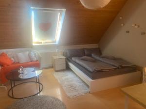 a living room with a bed and a window at Zentral im Grünen in Dortmund +1 photo