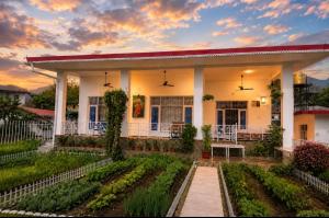 a house with a garden in front of it at White View Park in Dharmsāla
