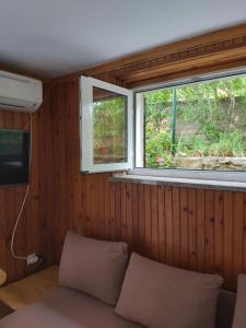 a small room with a couch and a window at Villa Kate in Krk