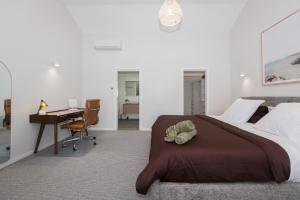 a bedroom with a bed and a desk and a computer at Breakwall Retreat in Manning Point +34 photos