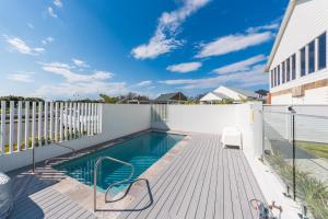 a swimming pool on the deck of a house at Breakwall Retreat in Manning Point