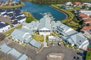 an aerial view of a house with a marina at Breakwall Retreat in Manning Point