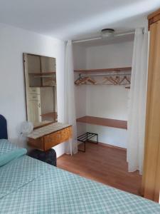 a bedroom with a bed and a desk and a mirror at Villa Kate in Krk