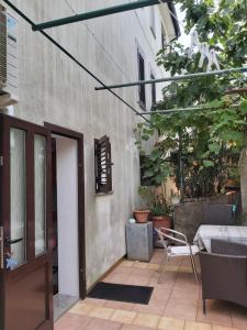 a patio with a door and a chair next to a building at Villa Kate in Krk