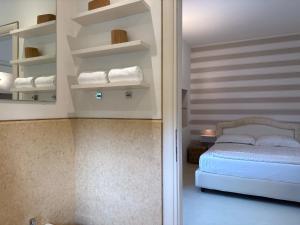 a bedroom with a bed and a mirror and towels at franciacorta iseo lake house in Clusane sul Lago +42 photos