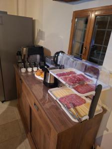 a kitchen counter with meat and other foods on it at B&B Dimora D'Alfano in SantʼAngelo in Pontano