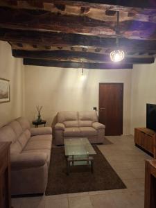 a living room with two couches and a coffee table at B&B Dimora D'Alfano in SantʼAngelo in Pontano