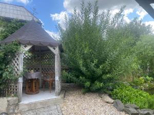 a gazebo with a table and chairs in a garden at Rodinný dům Na Sibiři in Ledeč nad Sázavou