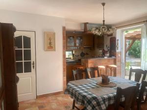 a kitchen and dining room with a table and chairs at Rodinný dům Na Sibiři in Ledeč nad Sázavou