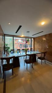 a dining room with tables and chairs and a large window at Multiple Hotels in Malam Jabba Swat in Malam Jabba