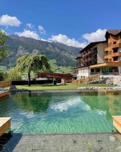 a large pool of water in front of a building at Naturhotel Outside in Matrei in Osttirol