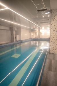 a large swimming pool in a building at Salis Hotel & Medical Spa in Turda