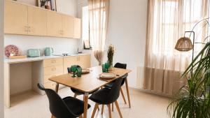 a kitchen with a wooden table and chairs at Four Stories Lefkara in Pano Lefkara +24 photos