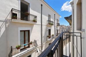 an alley with balconies and potted plants at Domus dell'Angelo in Monte SantʼAngelo