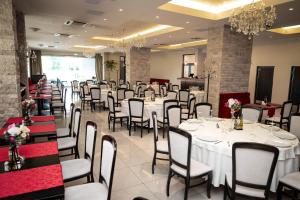 a banquet hall with white tables and chairs at Salis Hotel & Medical Spa in Turda