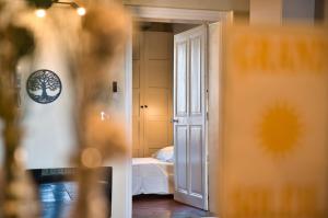 an open door to a bedroom with a bed at Elegant apartment with balcony - Maison Comte in Uzès
