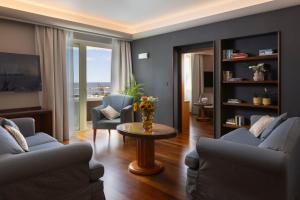 a living room with chairs and a table with flowers on it at Hotel More in Dubrovnik