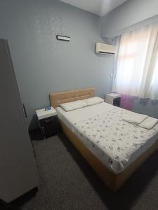 a bedroom with a bed and a window at Sunrise Hotel in Antalya