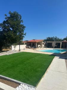 a yard with a swimming pool and a house at Hidden Villa in Klarići