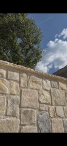 a stone wall with a tree in the background at Hidden Villa in Klarići +29 photos