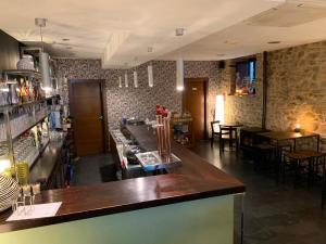 a bar in a restaurant with tables and chairs at Hostal Ultreia in Villafranca del Bierzo