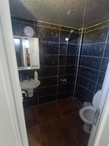 a bathroom with a toilet and a sink at Sunrise Hotel in Antalya