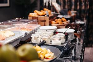 a buffet line with food and jams and other foods at Grey Street Hotel in Newcastle upon Tyne