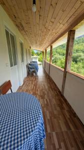 a room with a table with a blue and white checkered bed at Guests house, Artani in Valbonë +25 photos