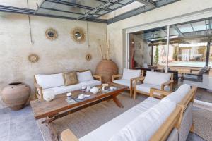 a living room with a couch and a table at Maison Bacchus 31 in Buzet-sur-Tarn