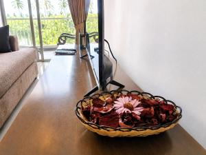 a bowl of flowers on a table in a living room at Signature 2BR - Deluxe - Santorini - Negombo in Negombo