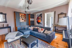 a living room with a couch and a table at Maison Bacchus 31 in Buzet-sur-Tarn