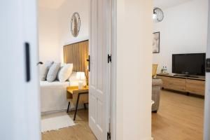 a bedroom with a bed and a television in a room at Cazorla a tus pies, en pleno centro con parking in Cazorla