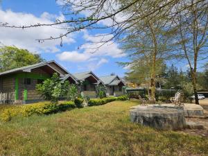 a house with a tree stump in the yard at Lala Inn in Gilgil