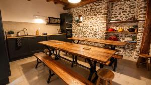 a kitchen with wooden tables and benches in a room at Gîte de l 'Annonciation in Lourdes +22 photos