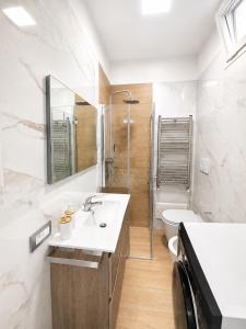 a bathroom with a sink and a toilet at Palazzo Solera in Casarano +25 photos