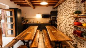 two wooden benches in a room with a kitchen at Gîte de l 'Annonciation in Lourdes