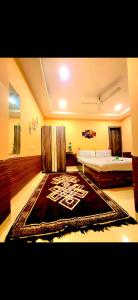 a bedroom with a bed and a rug on the floor at Galaxy Stellar Suites in kolkata