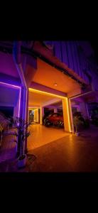 a house with purple lights on the side of it at Galaxy Stellar Suites in kolkata