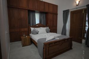 a bedroom with a bed with two towels on it at Cosy Concepts in Kovalam