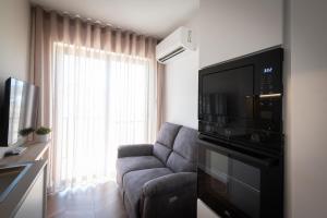a living room with a couch and a microwave at Electra Residence - Central Duplex Penthouse in Marsalforn