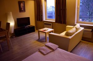 TV a/nebo společenská místnost v ubytování Ambassador Suites Antwerp