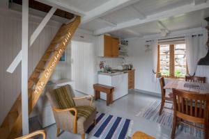 a kitchen and living room with a staircase in a house at The traditional Burekka 17 - Lofoten in Stamsund