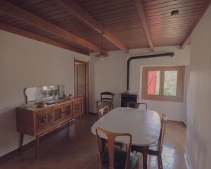 a kitchen and dining room with a table and chairs at Casetta dalle finestre rosse in Bedonia