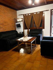 a living room with couches and a coffee table at Hotel & Restaurant Las Brisas in Puerto Esperanza