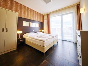 a bedroom with a bed and a large window at Rezidence Fontána in Teplice +45 photos