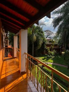 a balcony of a house with a view of a yard at Hotel & Restaurant Las Brisas in Puerto Esperanza