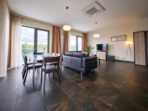 a living room with a couch and a table and chairs at Rezidence Fontána in Teplice