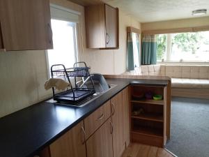 a kitchen with a sink and a counter top at Elli-Roo's cabin in Hartley +5 photos