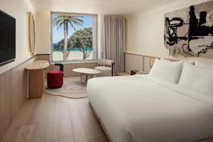 a hotel room with a large white bed and a window at Morea House, Autograph Collection in Cape Town +112 photos